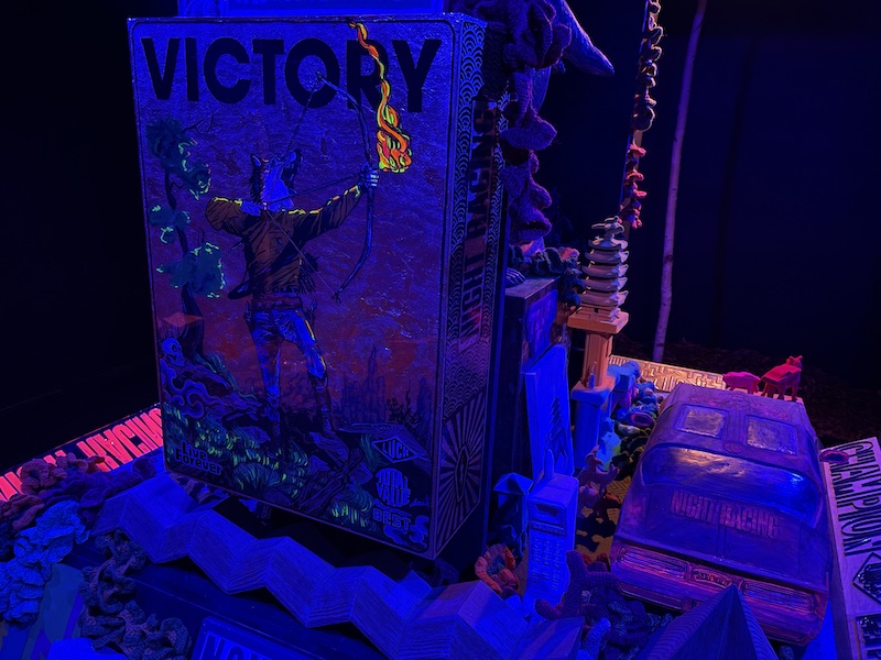 A glowing animal with a burning torch and the words Victory